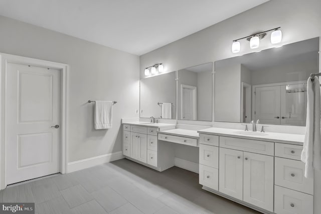 full bathroom with baseboards and vanity