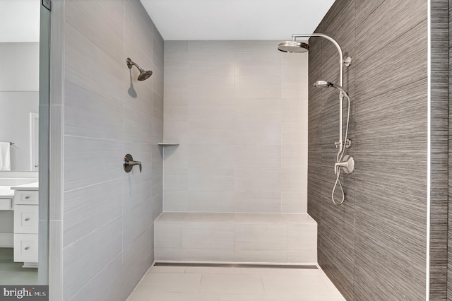 full bathroom with vanity and tiled shower