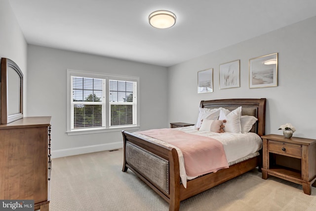 bedroom featuring baseboards and light colored carpet