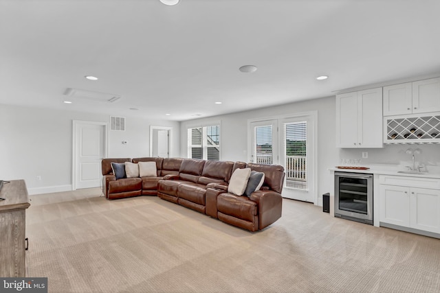 living room featuring visible vents, wine cooler, light carpet, indoor wet bar, and recessed lighting