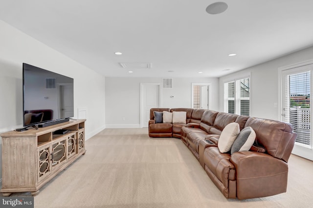 living room featuring recessed lighting, light colored carpet, visible vents, and baseboards