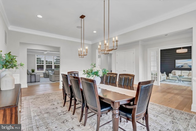 dining room with crown molding, light wood-style flooring, and recessed lighting