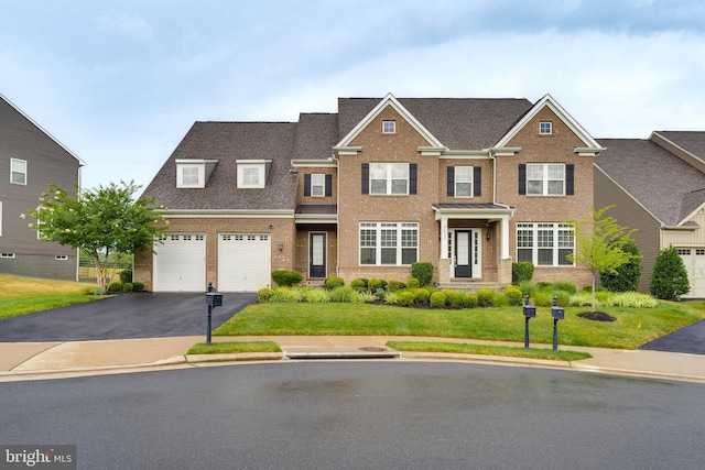 view of front of house featuring driveway, a front lawn, a shingled roof, a garage, and brick siding