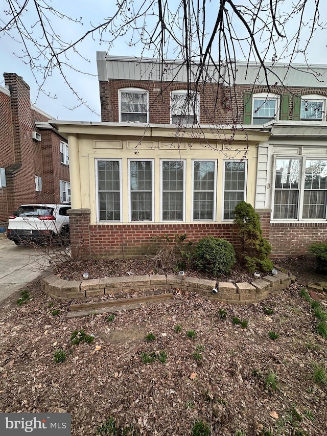 rear view of house with brick siding