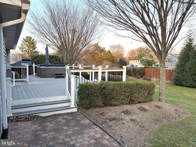 exterior space featuring a hot tub and fence