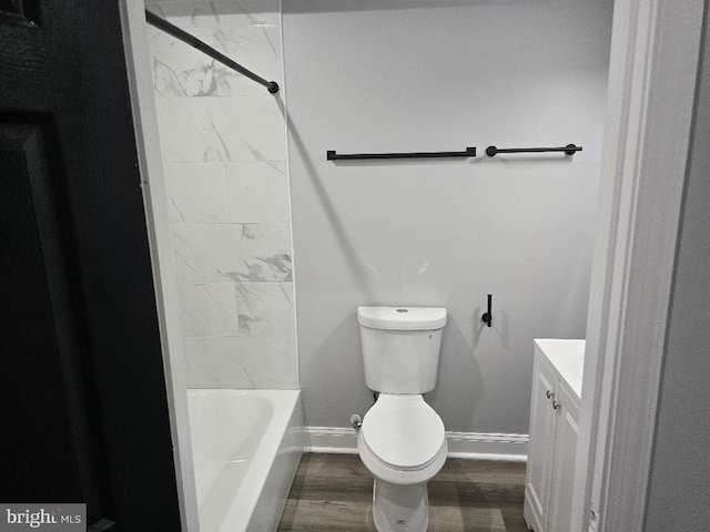 full bathroom featuring vanity, wood finished floors, baseboards, toilet, and shower / bathtub combination