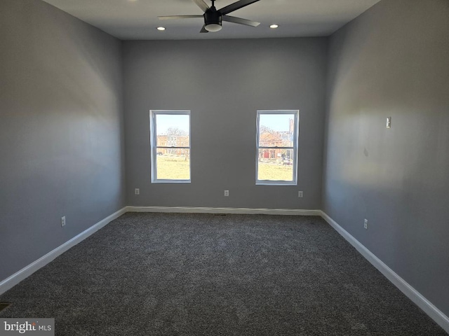 empty room featuring recessed lighting, ceiling fan, baseboards, and dark colored carpet