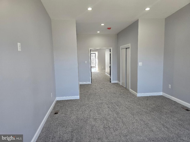 carpeted empty room featuring recessed lighting and baseboards