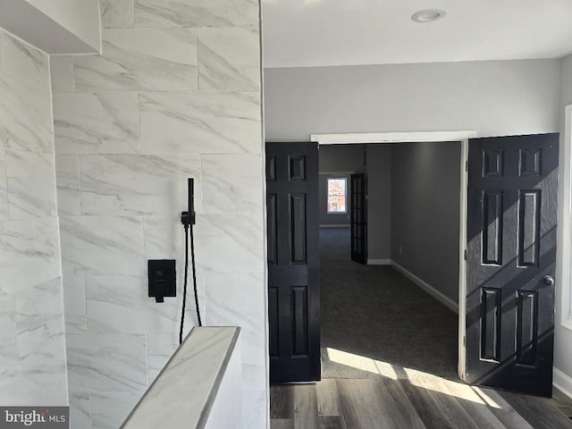 bathroom with baseboards and wood finished floors