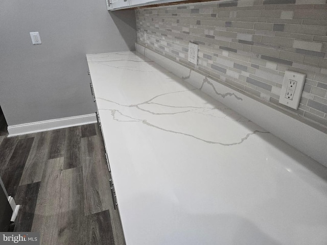 room details with backsplash, baseboards, and wood finished floors