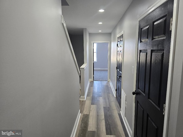 hall featuring recessed lighting, visible vents, baseboards, and dark wood-style floors