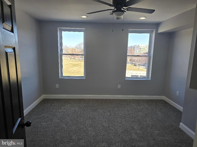 unfurnished room featuring dark colored carpet, baseboards, recessed lighting, and a ceiling fan