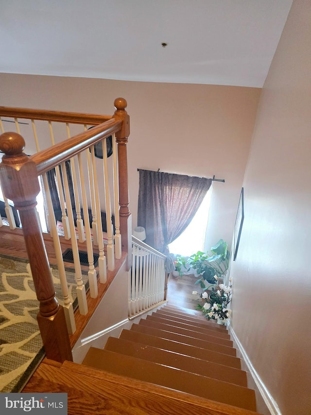 stairway featuring baseboards