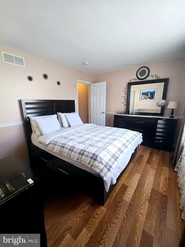 bedroom with wood finished floors and visible vents