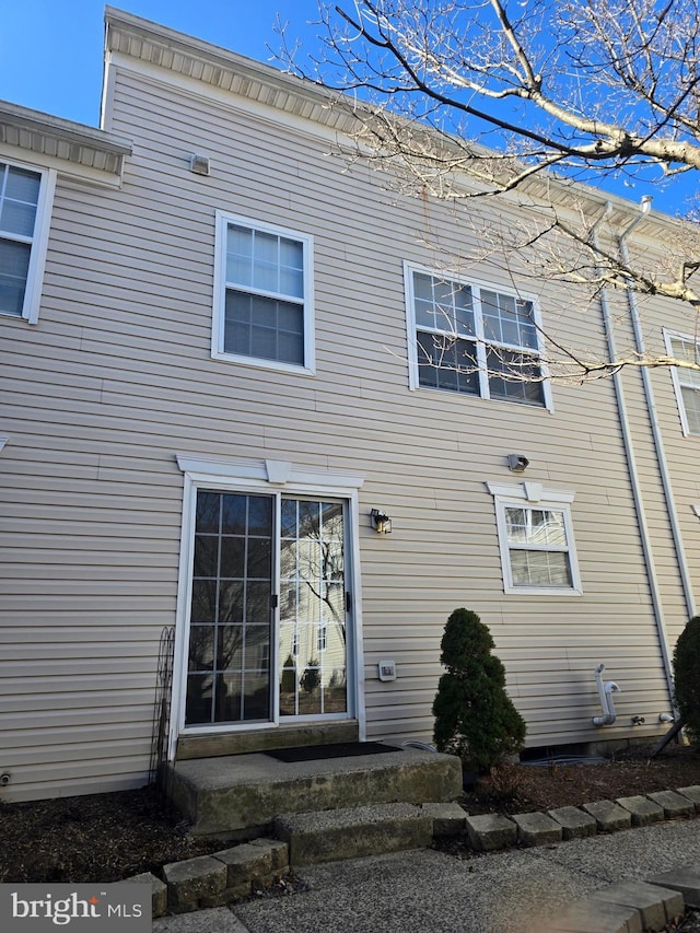 rear view of property featuring entry steps