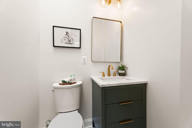 half bathroom with toilet and vanity