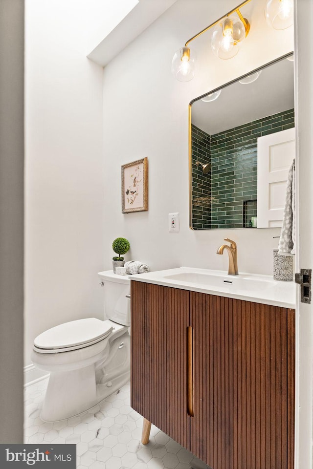 bathroom featuring toilet, vanity, and tile patterned flooring