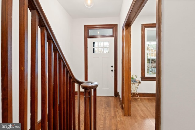 foyer entrance featuring stairway and light wood-style flooring