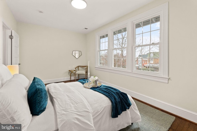 bedroom with wood finished floors and baseboards