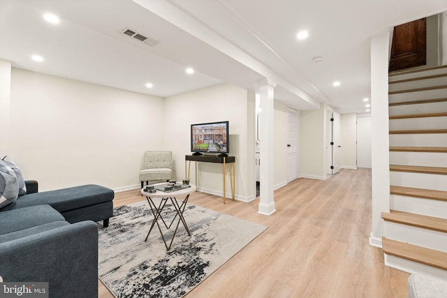 living room with visible vents, baseboards, light wood-style flooring, recessed lighting, and stairs