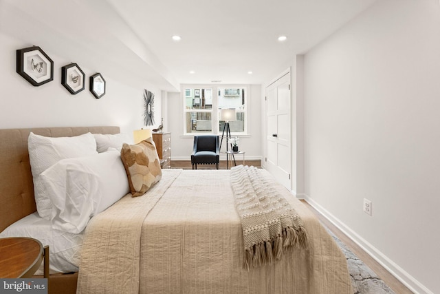 bedroom with recessed lighting, baseboards, and wood finished floors