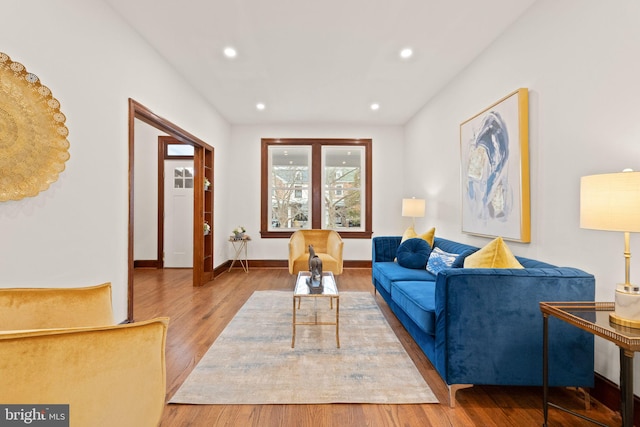 living area with recessed lighting, baseboards, and wood finished floors