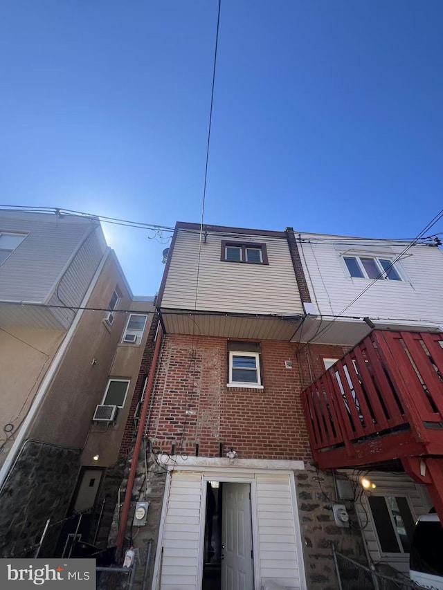 rear view of property featuring brick siding