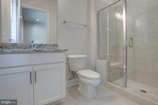 full bath with tile patterned floors, vanity, toilet, and a shower stall