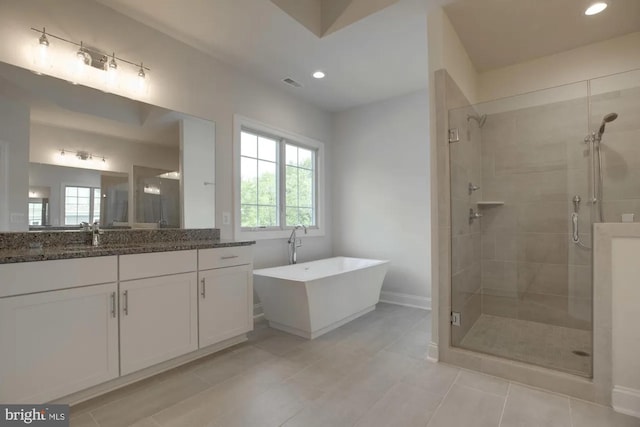 bathroom with a freestanding tub, visible vents, recessed lighting, a shower stall, and vanity