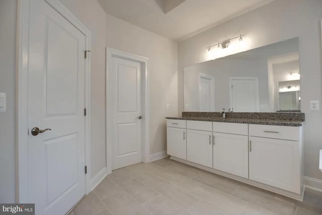 bathroom with vanity and baseboards