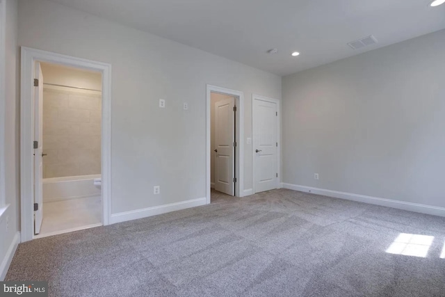 unfurnished bedroom featuring visible vents, baseboards, and carpet