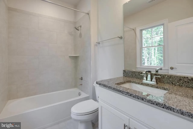 bathroom with shower / bath combination, toilet, and vanity