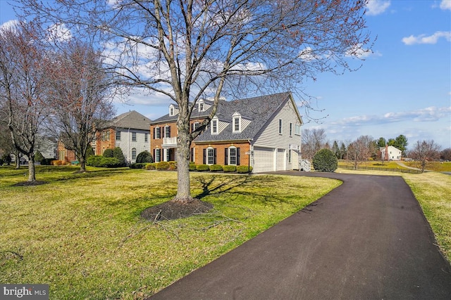 view of front facade featuring brick siding, driveway, an attached garage, and a front lawn