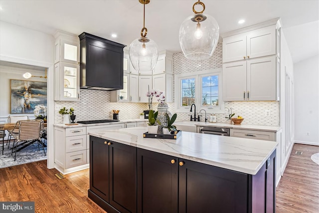 kitchen featuring gas cooktop, wood finished floors, and white cabinets