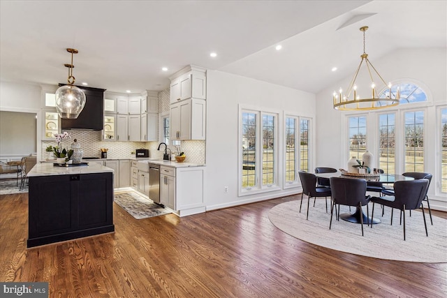 dining space with recessed lighting, lofted ceiling, dark wood-type flooring, and a chandelier