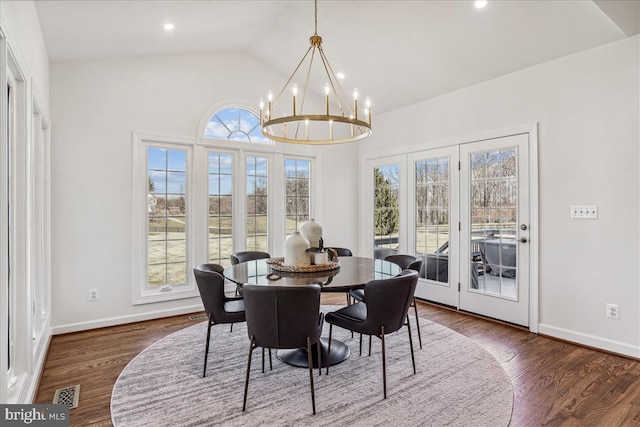 dining space featuring baseboards, a notable chandelier, dark wood-style flooring, and vaulted ceiling