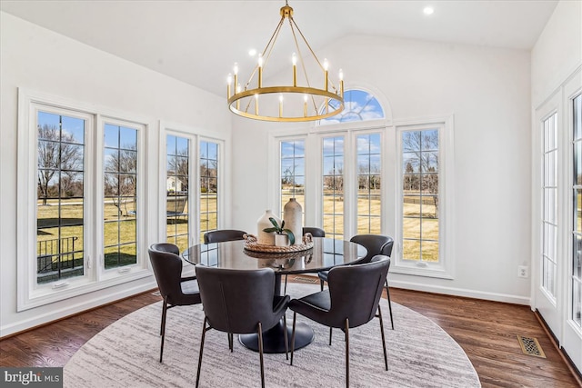 dining room with visible vents, baseboards, vaulted ceiling, a notable chandelier, and dark wood-style flooring