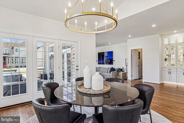 dining space featuring recessed lighting, wood finished floors, and a chandelier