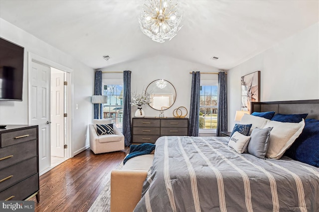 bedroom featuring a chandelier, visible vents, wood finished floors, and vaulted ceiling