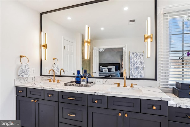 ensuite bathroom featuring visible vents, a sink, ensuite bath, recessed lighting, and double vanity