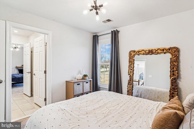 bedroom featuring light tile patterned floors, visible vents, light colored carpet, and a chandelier