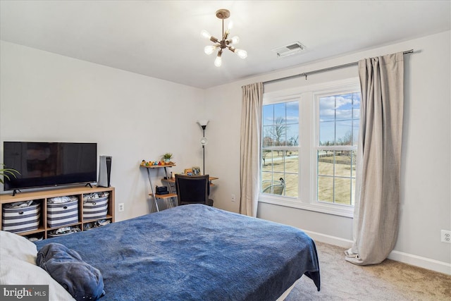 carpeted bedroom with visible vents, baseboards, and a chandelier