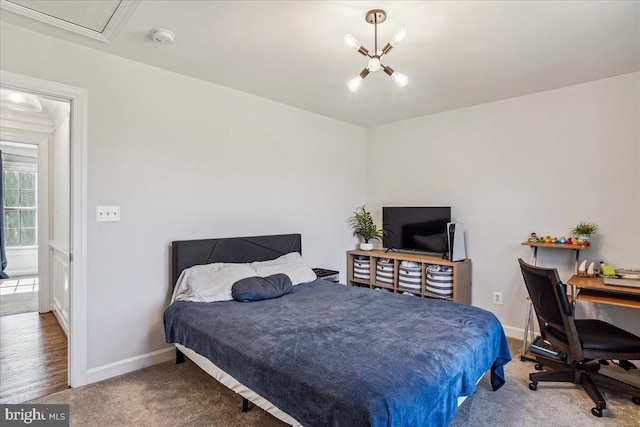 bedroom with baseboards, a chandelier, and carpet flooring