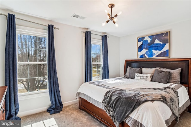 bedroom featuring multiple windows, baseboards, visible vents, and carpet floors