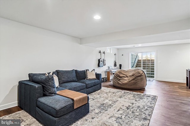 living room featuring recessed lighting, baseboards, and dark wood-type flooring