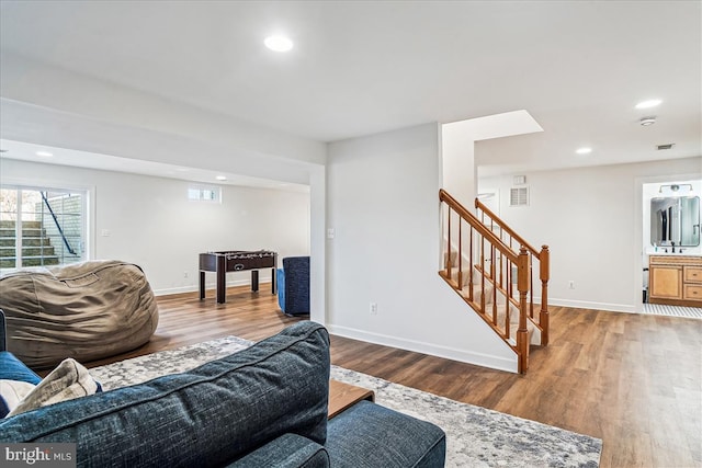 living room with visible vents, baseboards, stairway, recessed lighting, and wood finished floors