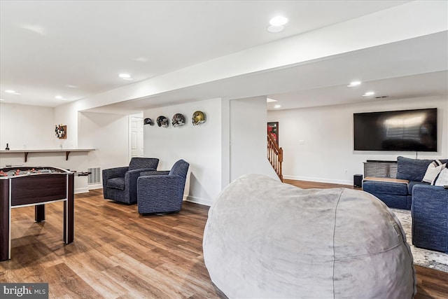 living area featuring recessed lighting, wood finished floors, and baseboards