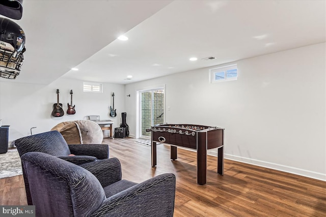 recreation room featuring recessed lighting, visible vents, a healthy amount of sunlight, and wood finished floors