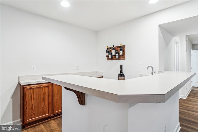 bar featuring recessed lighting, dark wood-style floors, and baseboards