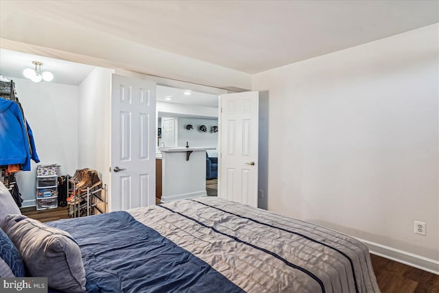 bedroom with baseboards and wood finished floors